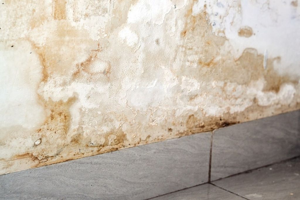 White wall with yellow stains showing moisture damage and discoloration patterns