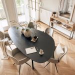 Rustic wooden dining table with natural grain and weathered finish showcasing wabi sabi furniture aesthetic in minimalist dining room