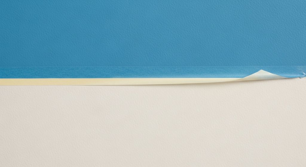 Close-up of clean, sharp paint lines on a freshly painted wall achieved using proper home painting hacks and painter's tape technique.